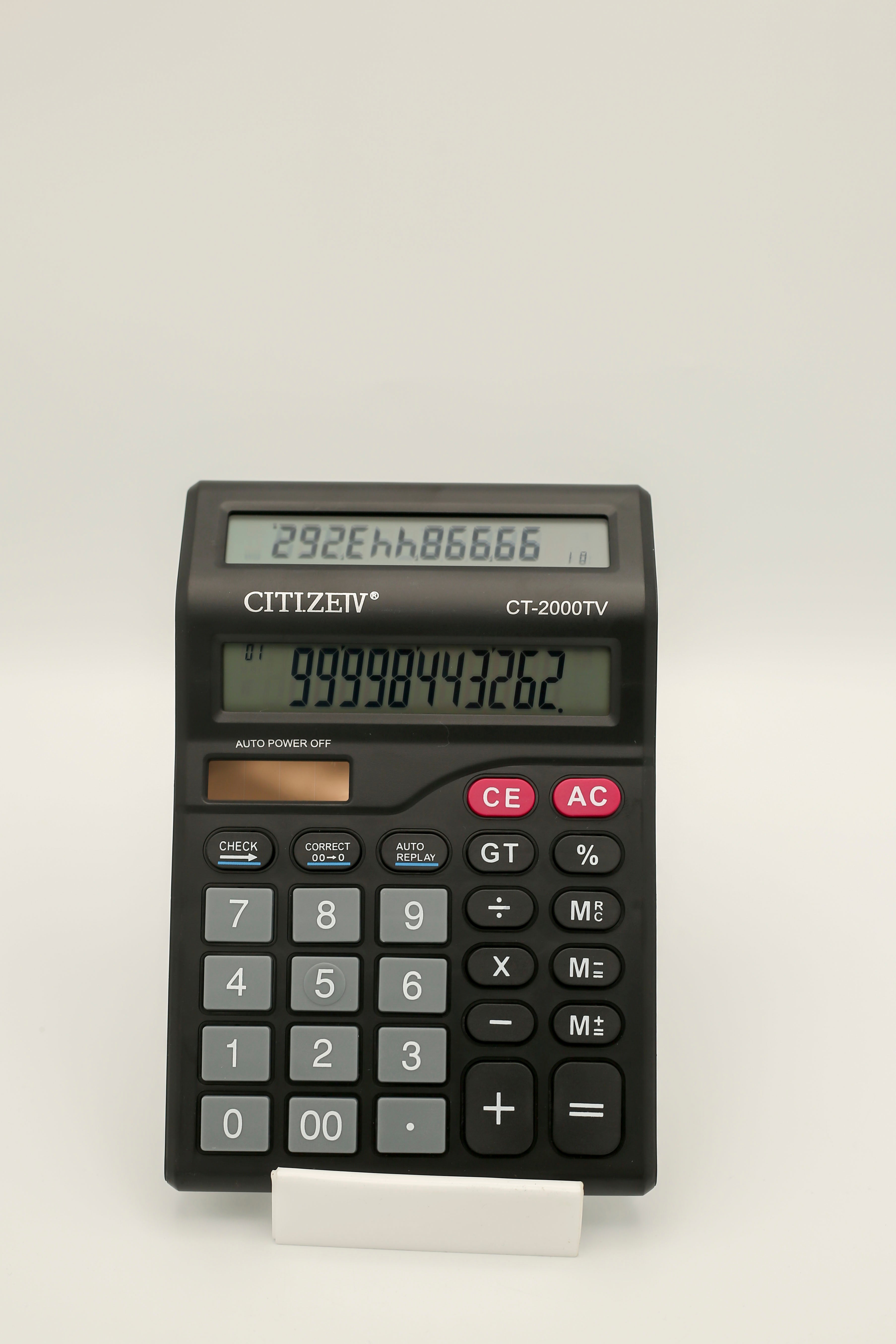 A Citizen CT-2000 desktop calculator with a large display screen, showing the time and multiple function options.